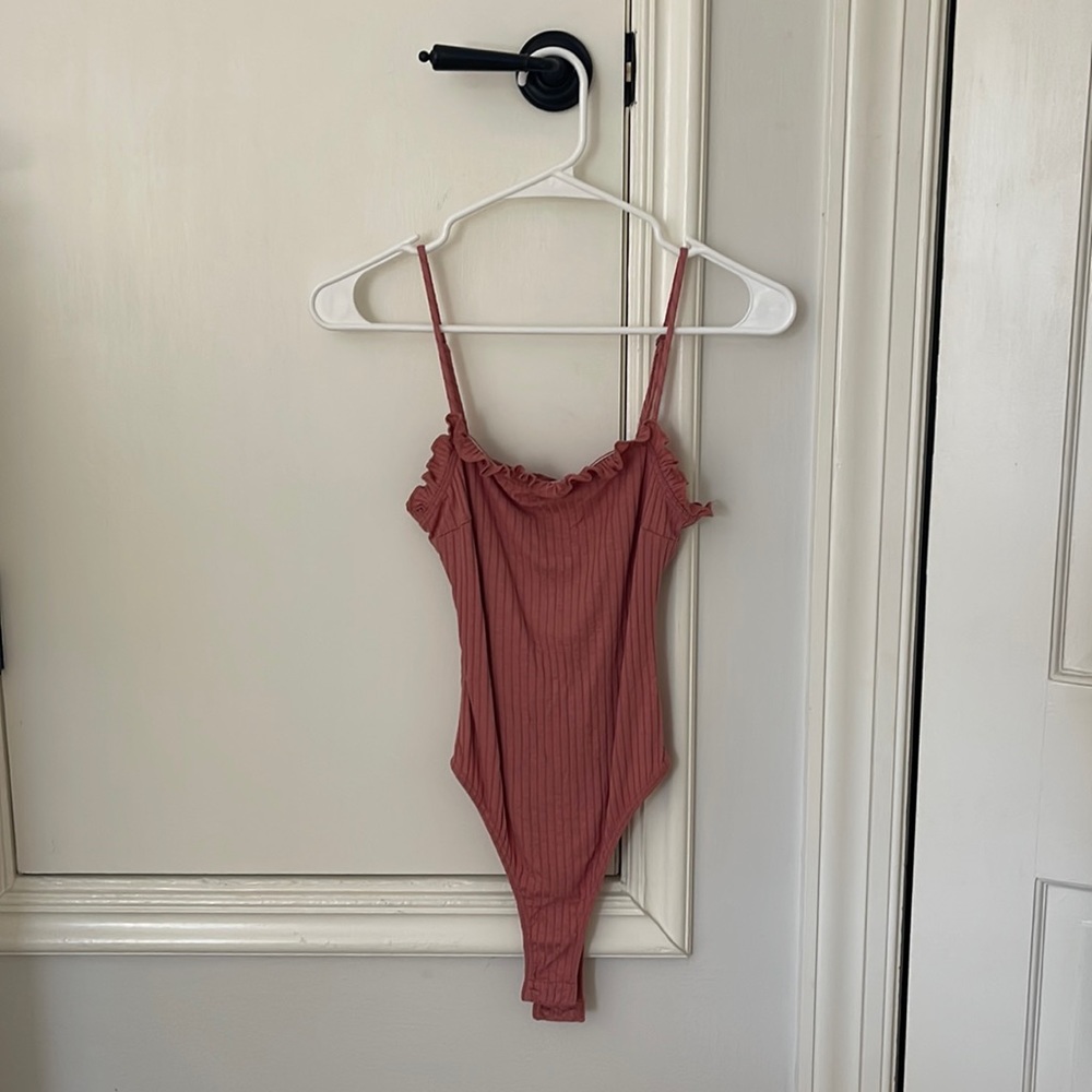 All In Favor light maroon bodysuit